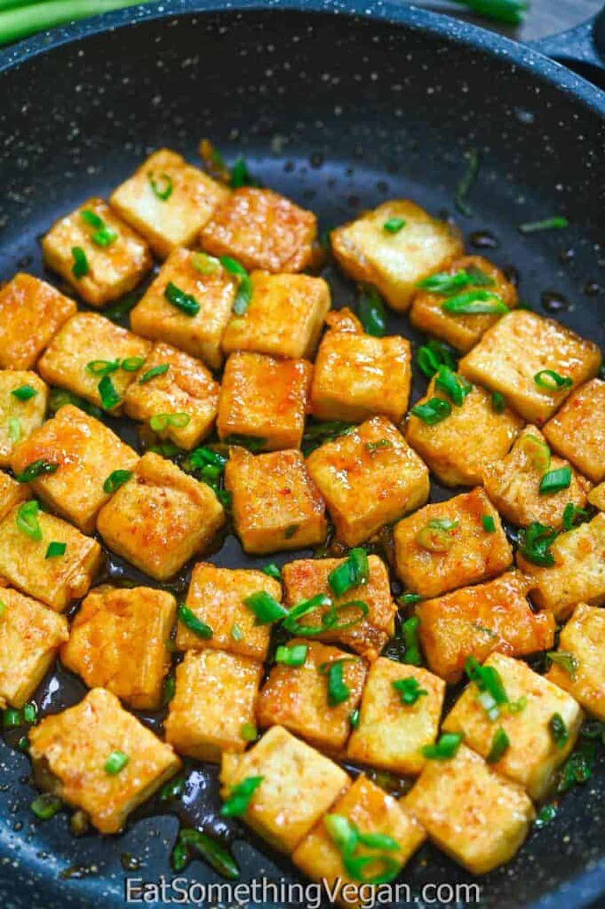 Close-up of Tofu Cubes coated in Sweet Sriracha Sauce.