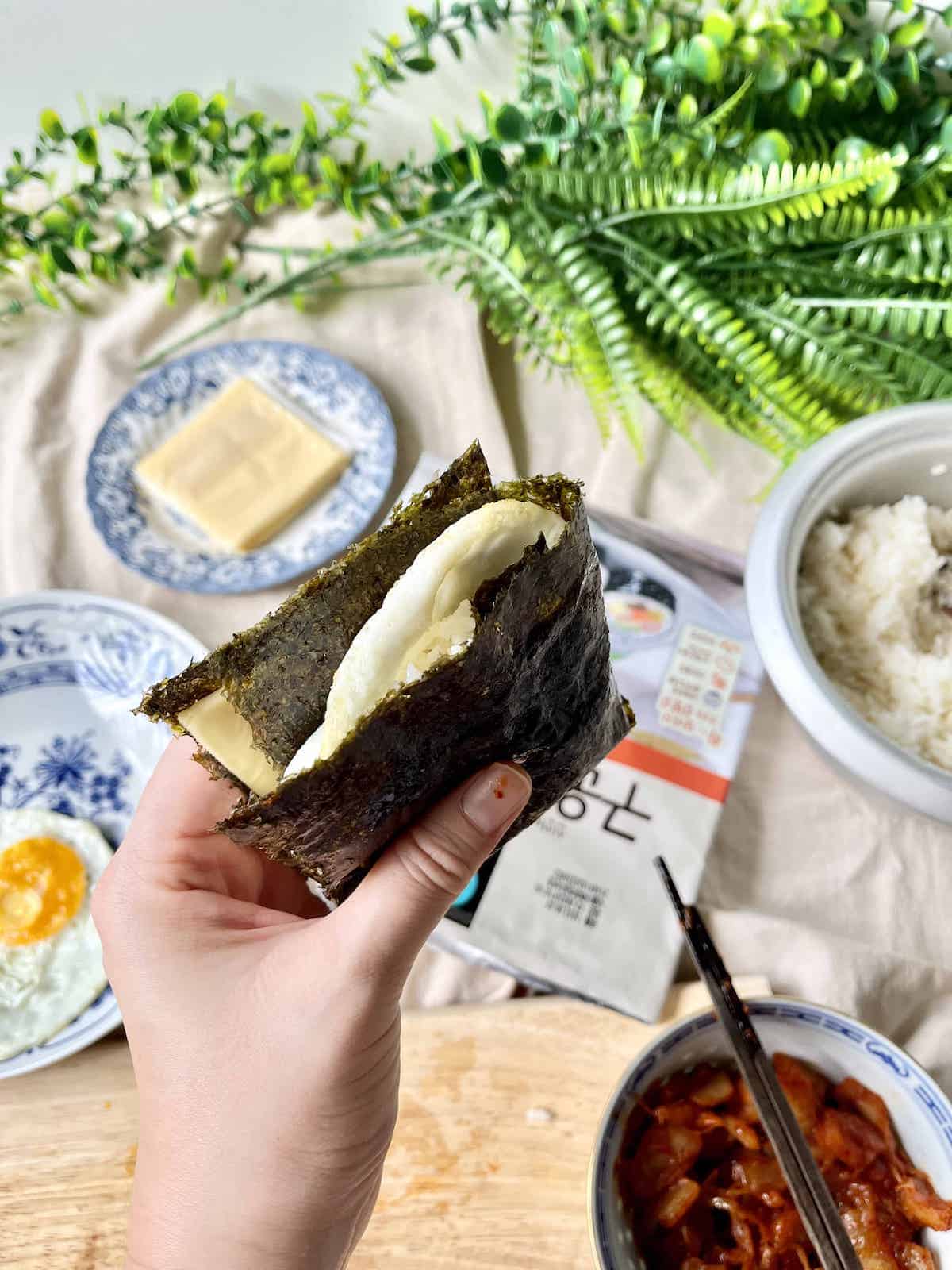 Side view of a Folded Kimbap Sandwich with egg sticking out.