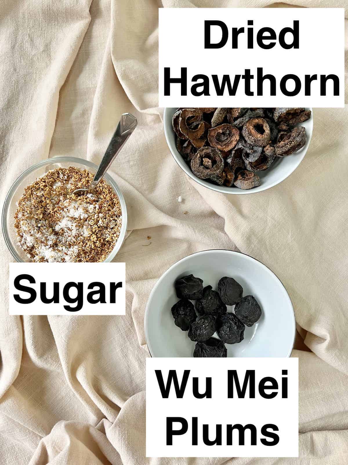Osmanthus sugar, wu Mei preserved Chinese plums and dried hawthorn slices in bowls.