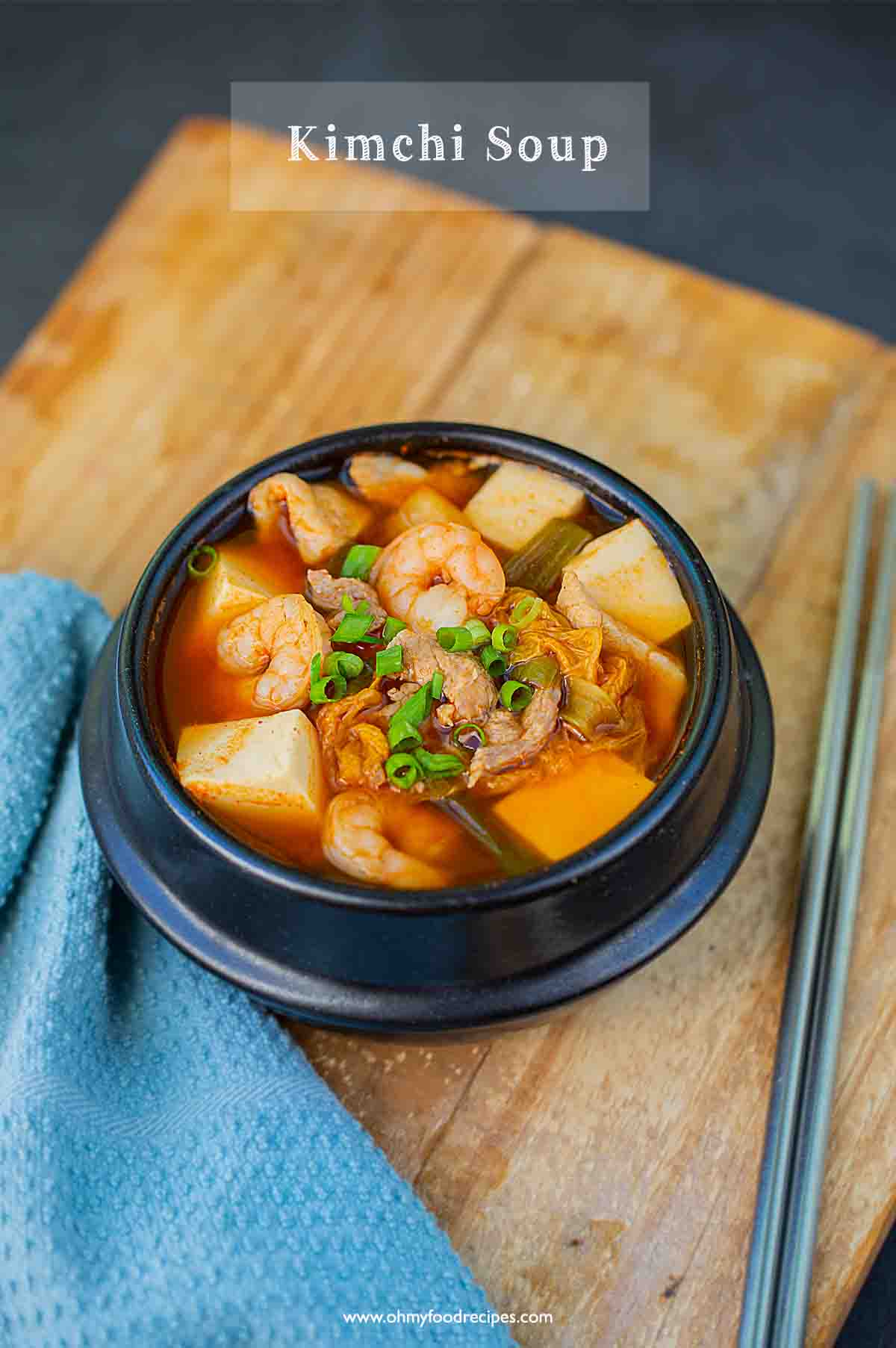 A photo of Korean Kimchi soup in a traditional Korean black soup bowl.