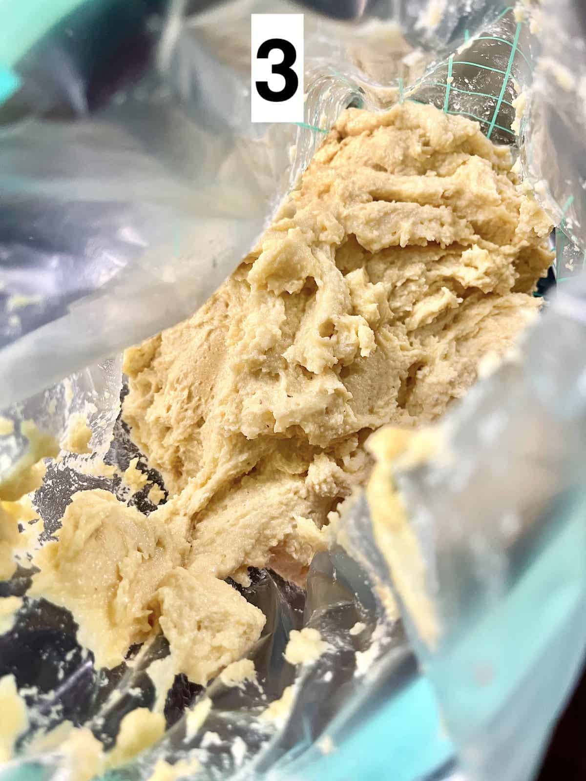 Close-up of American almond cookie dough in a Ziplock bag.