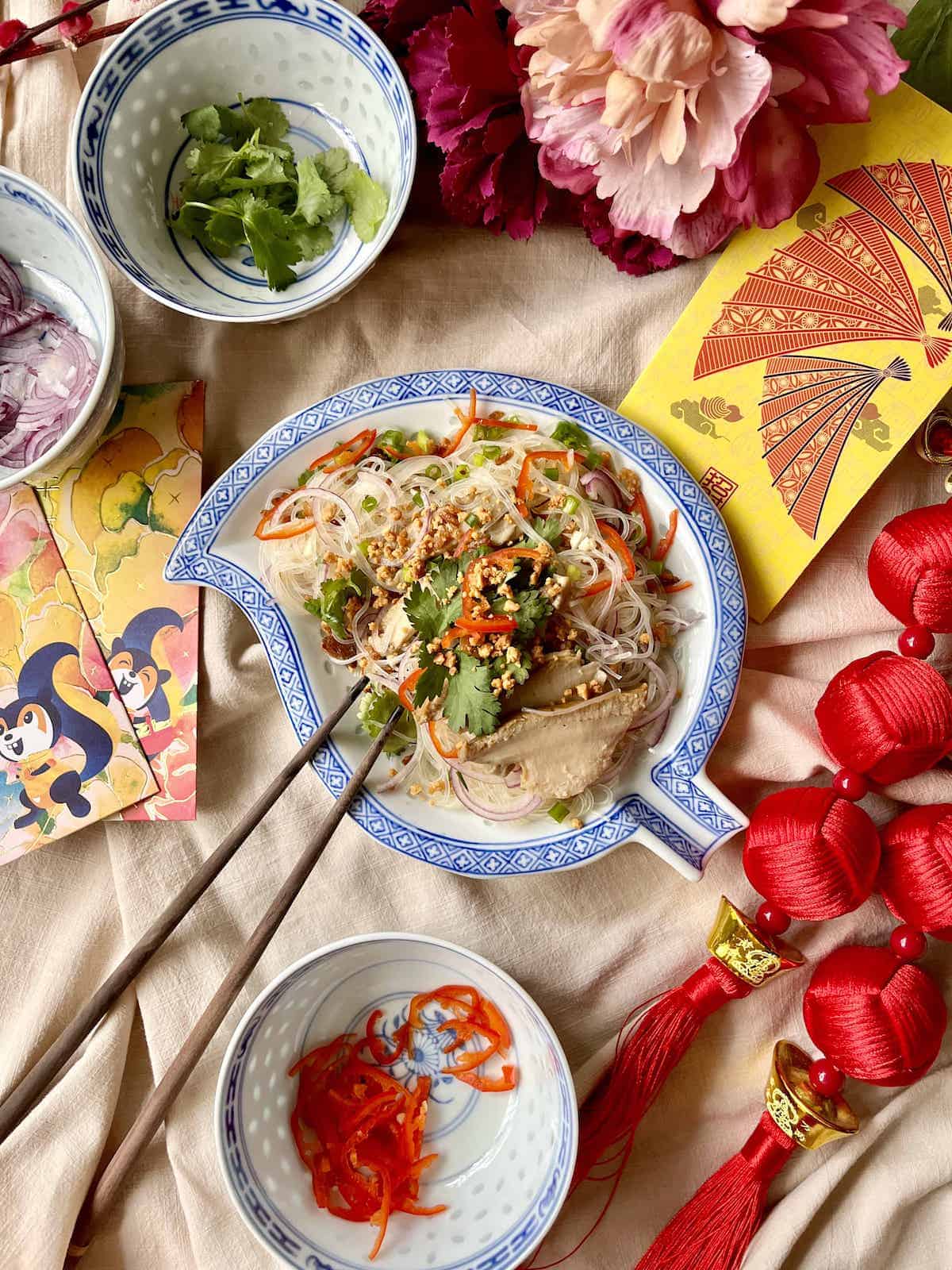 A plate of Thai vermicelli noodles amongst Chinese New Year decorations.