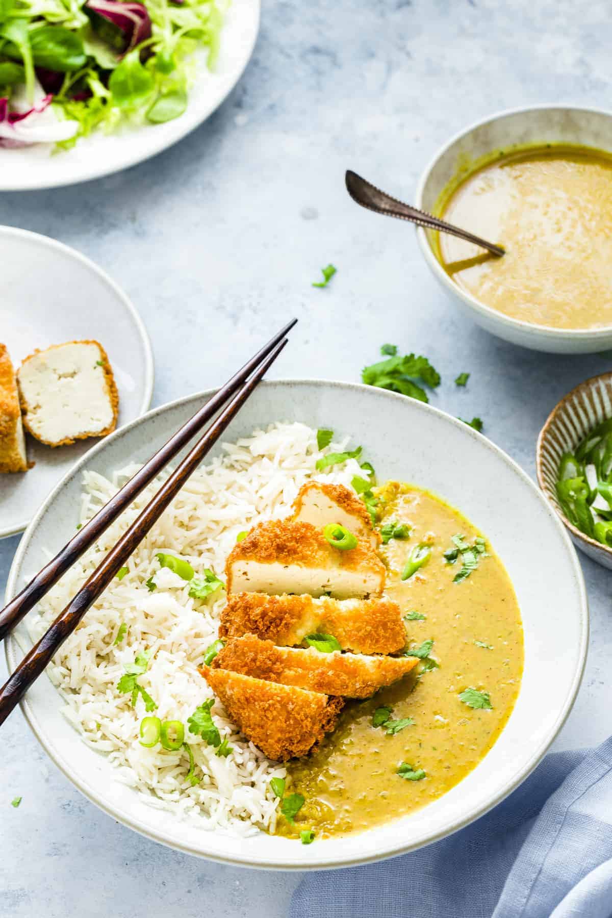 A plate of Tofu Katsu Curry with white rice.