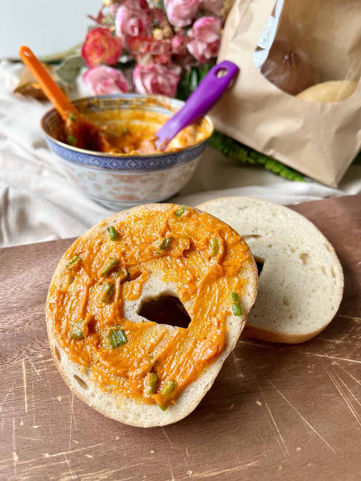 Gochujang butter and spring onions slathered on a bagel.