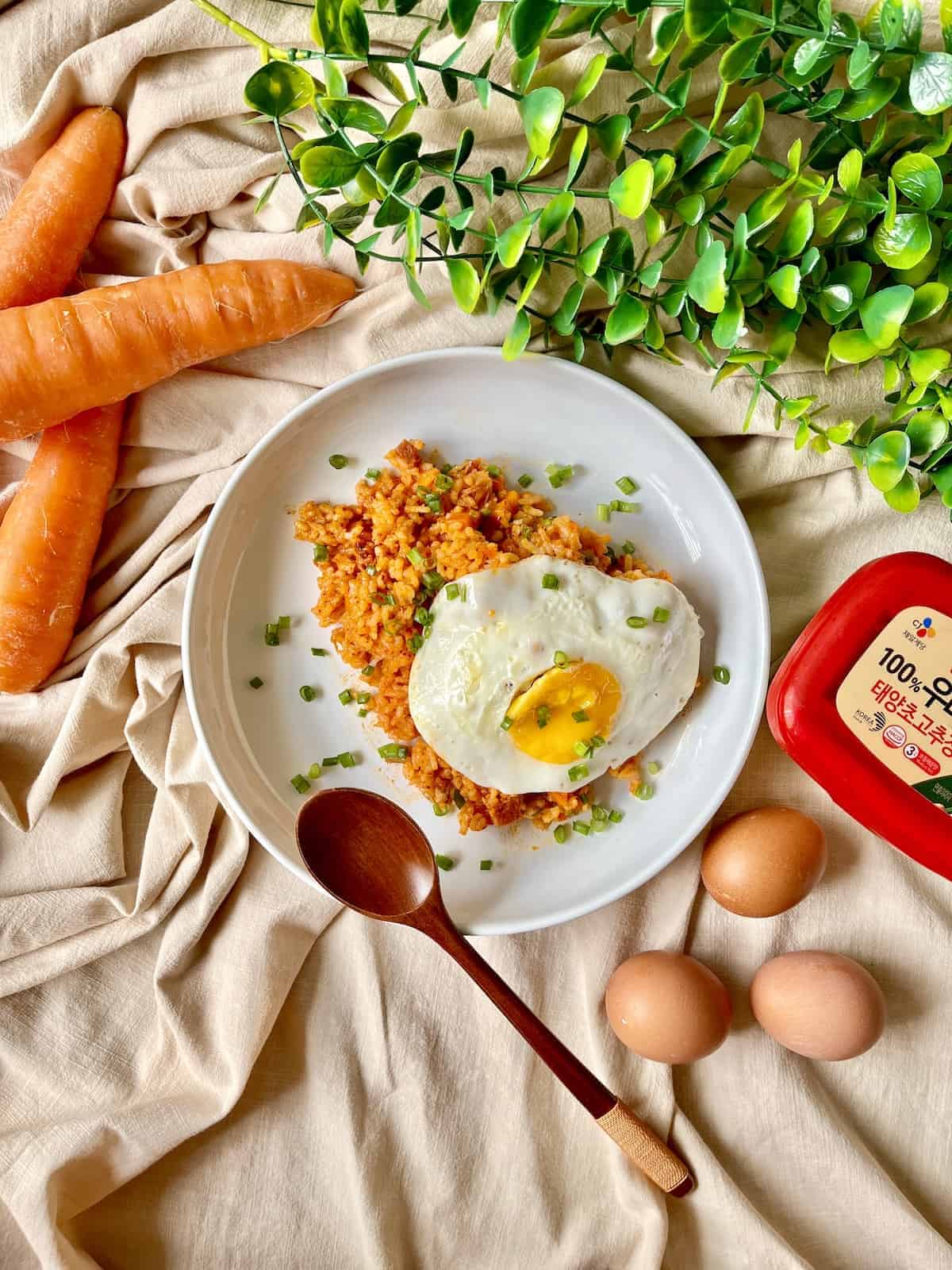 A plate of Korean fried rice with a sunny side egg.