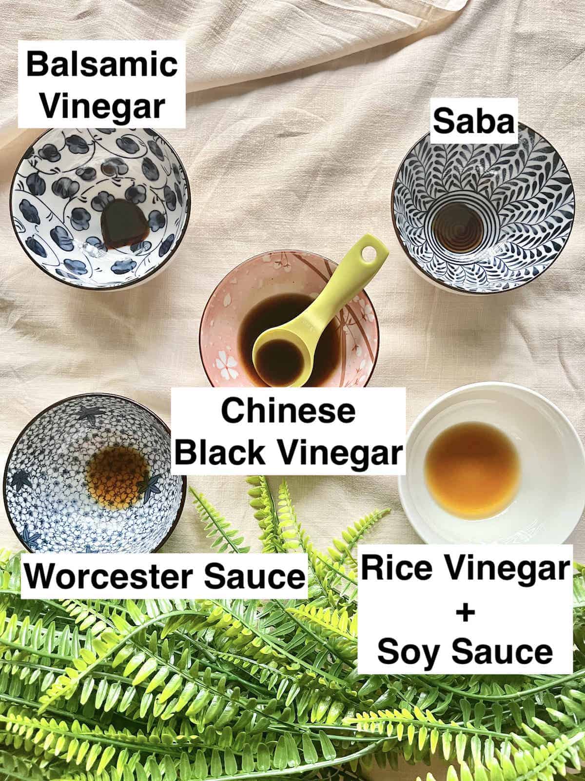 4 bowls of dark vinegars around a bowl of Chinkiang vinegar.