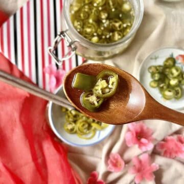 Close-up of a spoonful of Asian quick pickled green chilies.