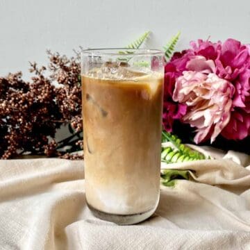 A glass of cold brew coffee with milk and ice.