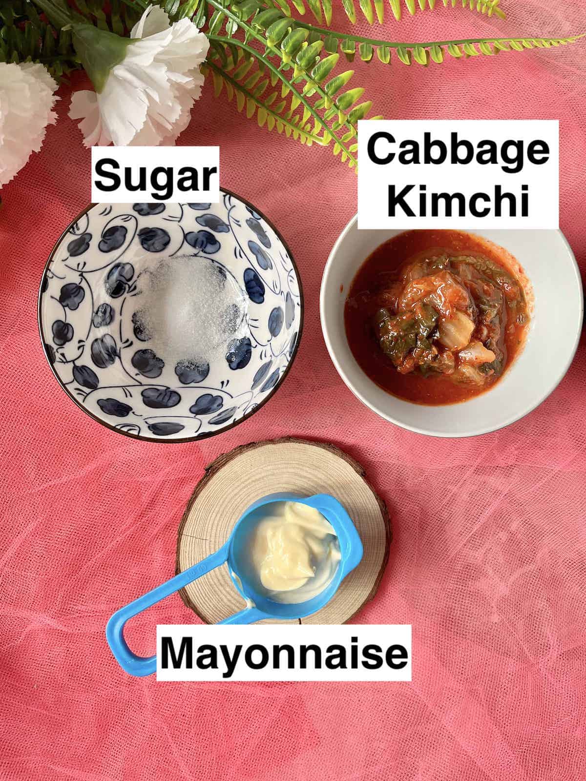 White sugar next to Korean kimchi and Mayonnaise.
