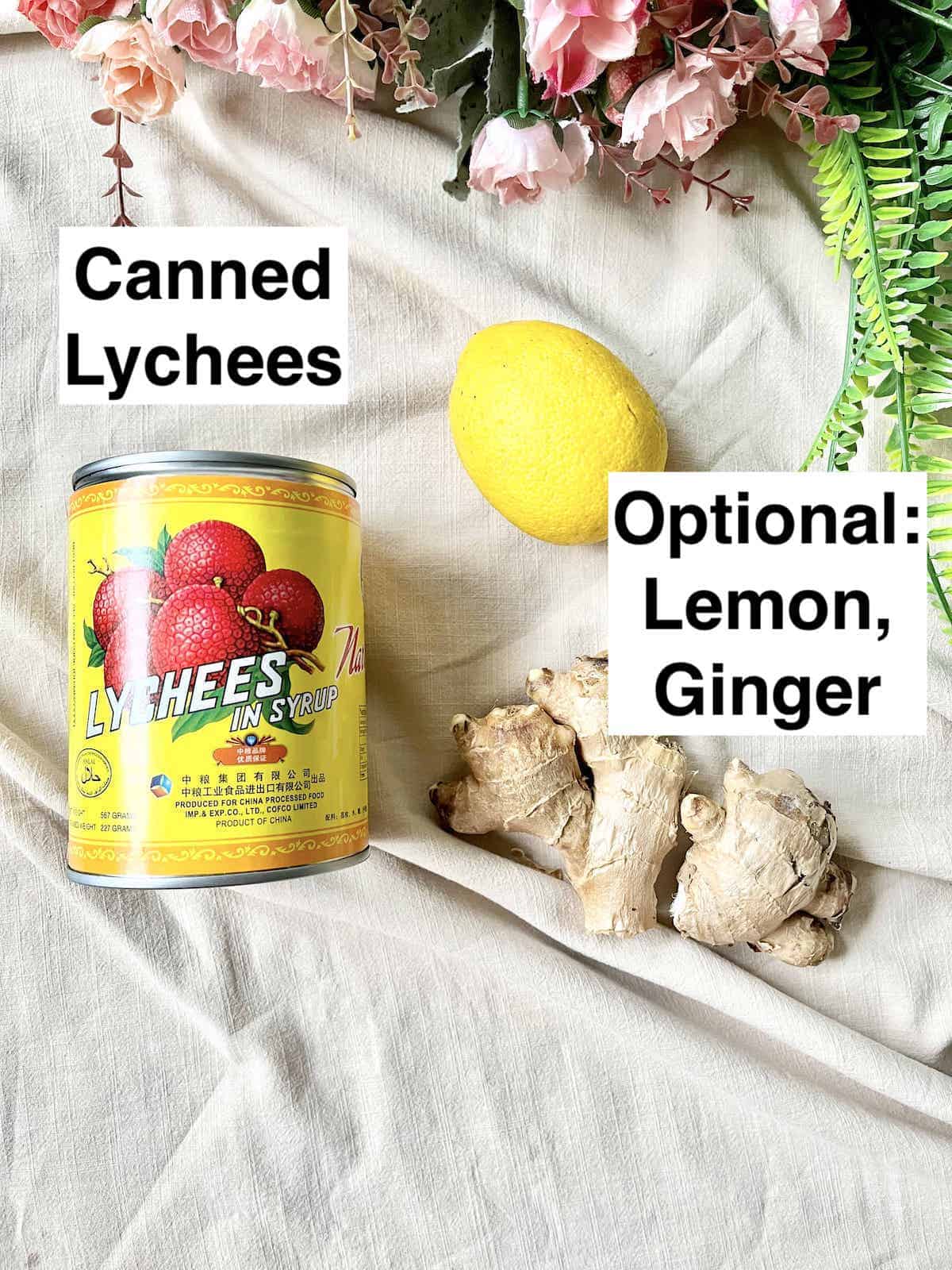 A can of lychees next to a lemon and ginger.
