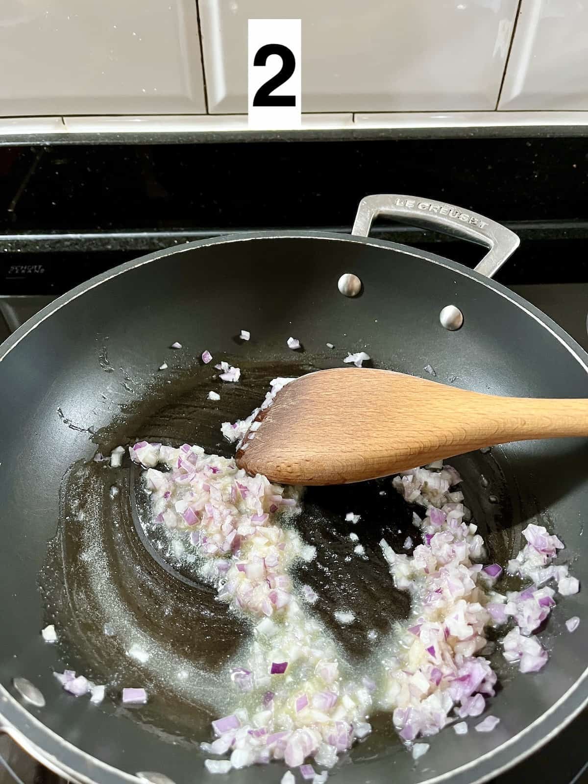 Stir frying minced onion and garlic in butter.