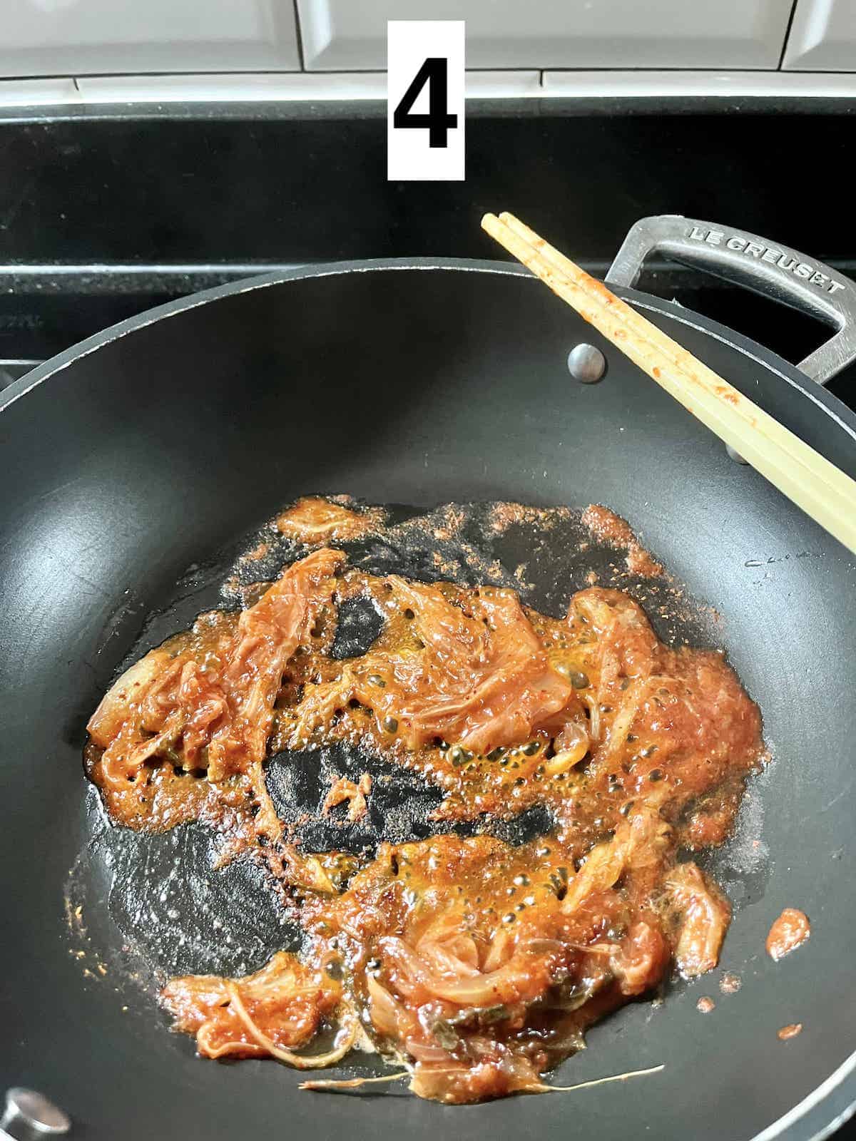 Kimchi sizzling in a pan.