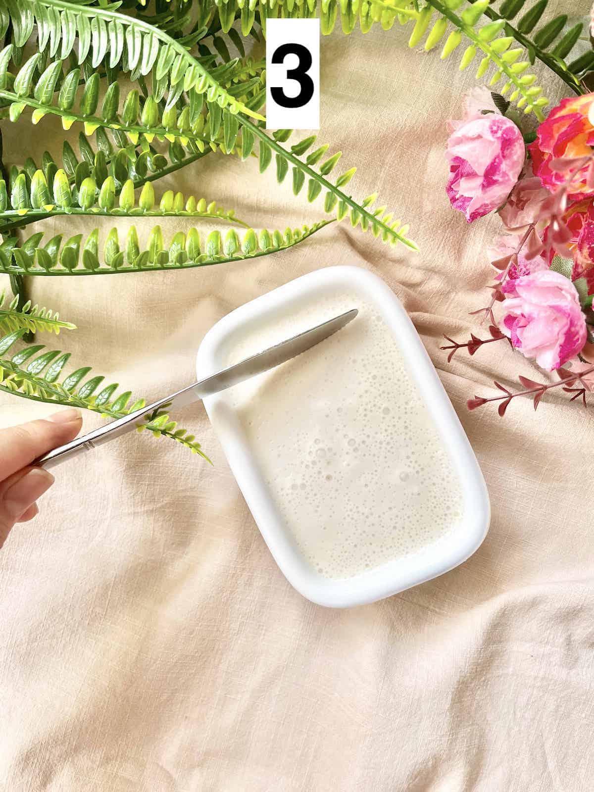 Cutting coconut milk agar agar jelly into cubes.