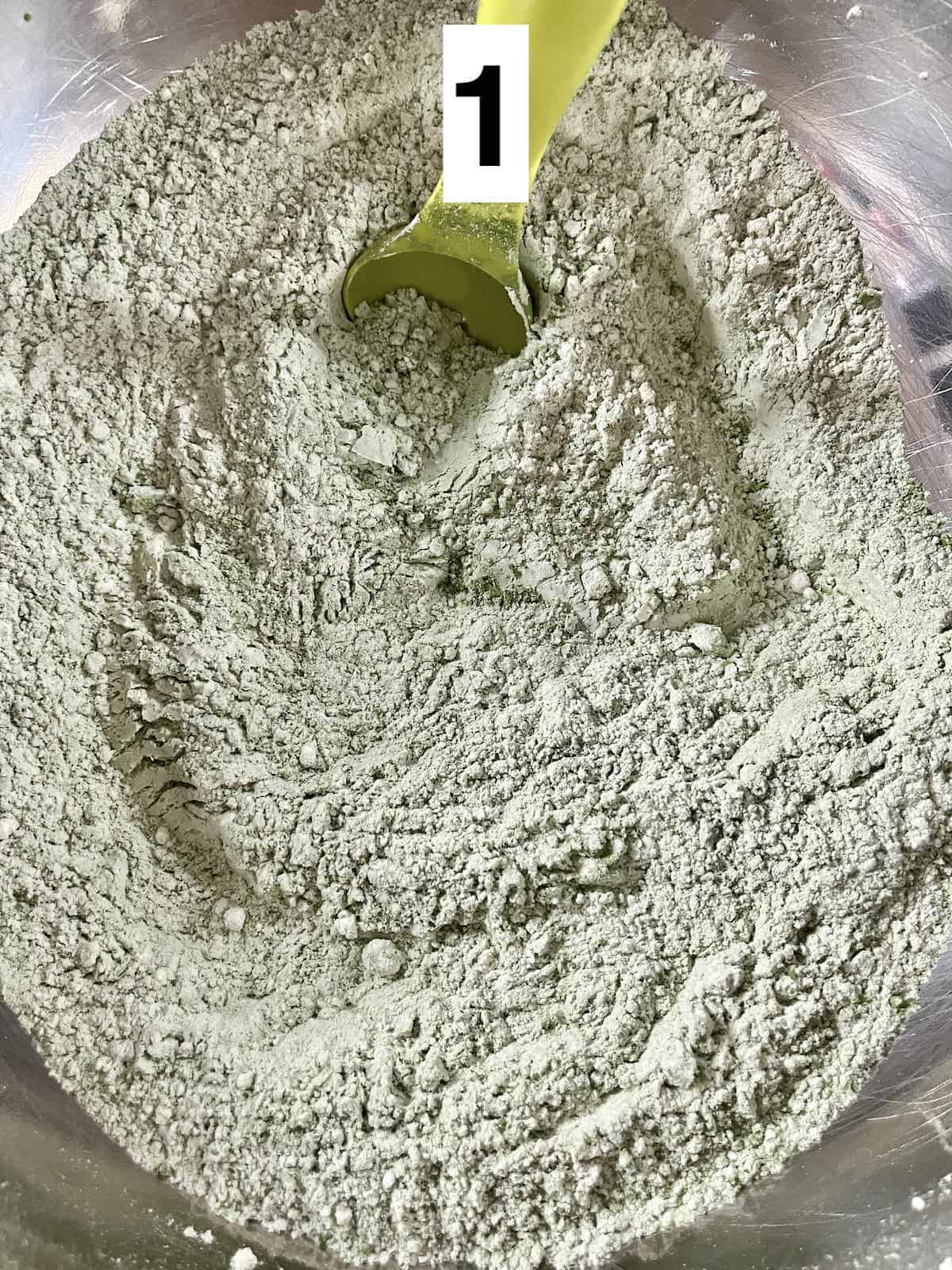 A bowl of matcha green tea powder mixed with white flour.
