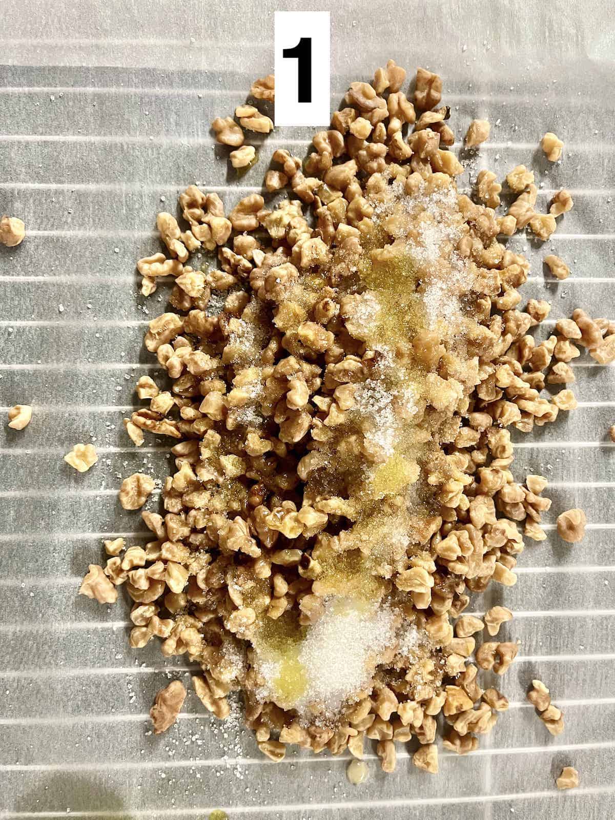 Walnuts, sugar, and oil on parchment paper.
