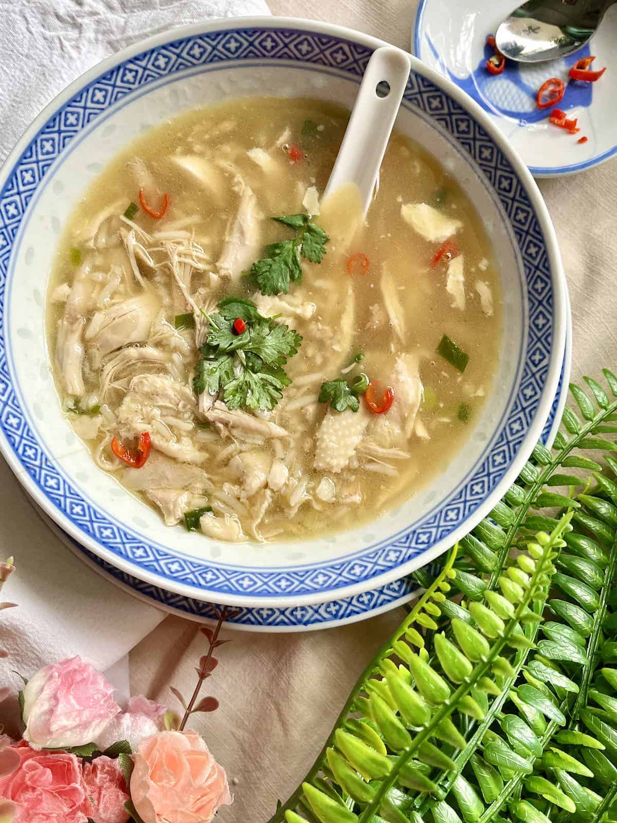 A bowl of chicken soup with rice, made with leftover roast chicken meat.