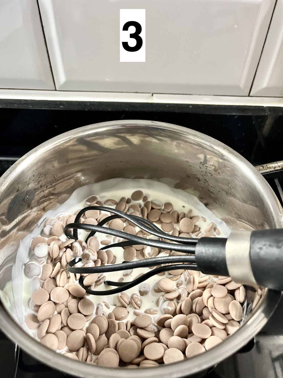 Whisking Ruby Chocolate into hot cream.