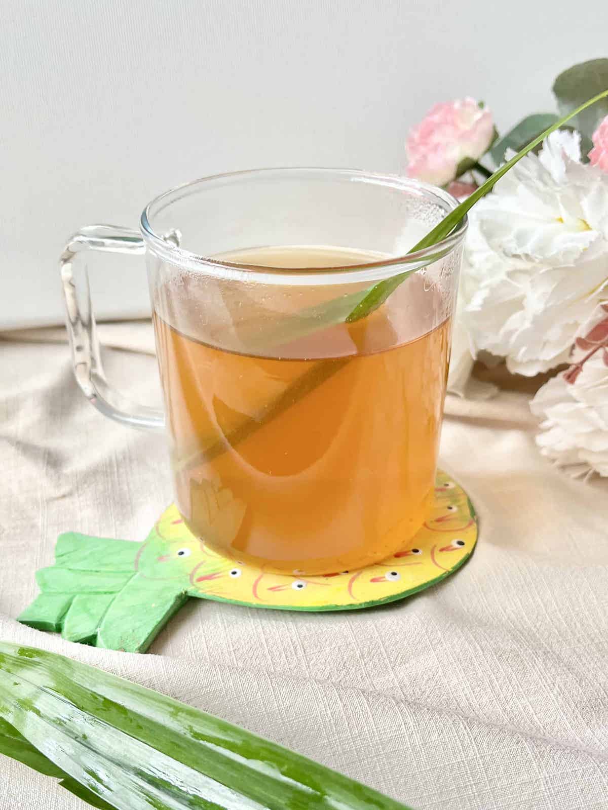 Cup of homemade fresh pandan leaf tea in a glass cup.