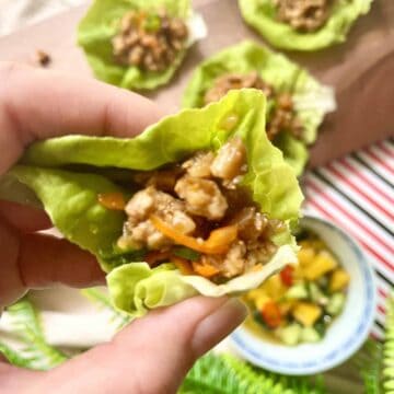 Holding up a homemade pork lettuce wrap.