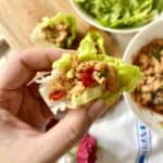 Close-up of a teriyaki salmon lettuce wrap.