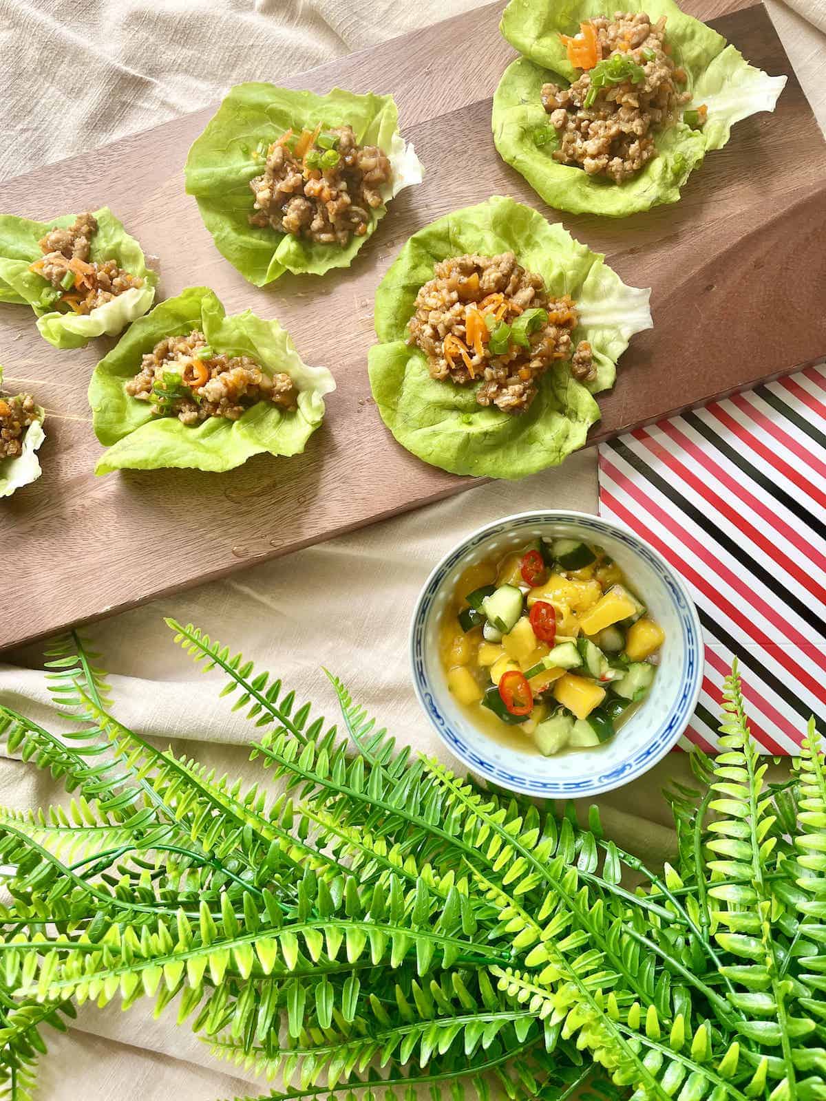 San chow bow lettuce cups next to mango salad.