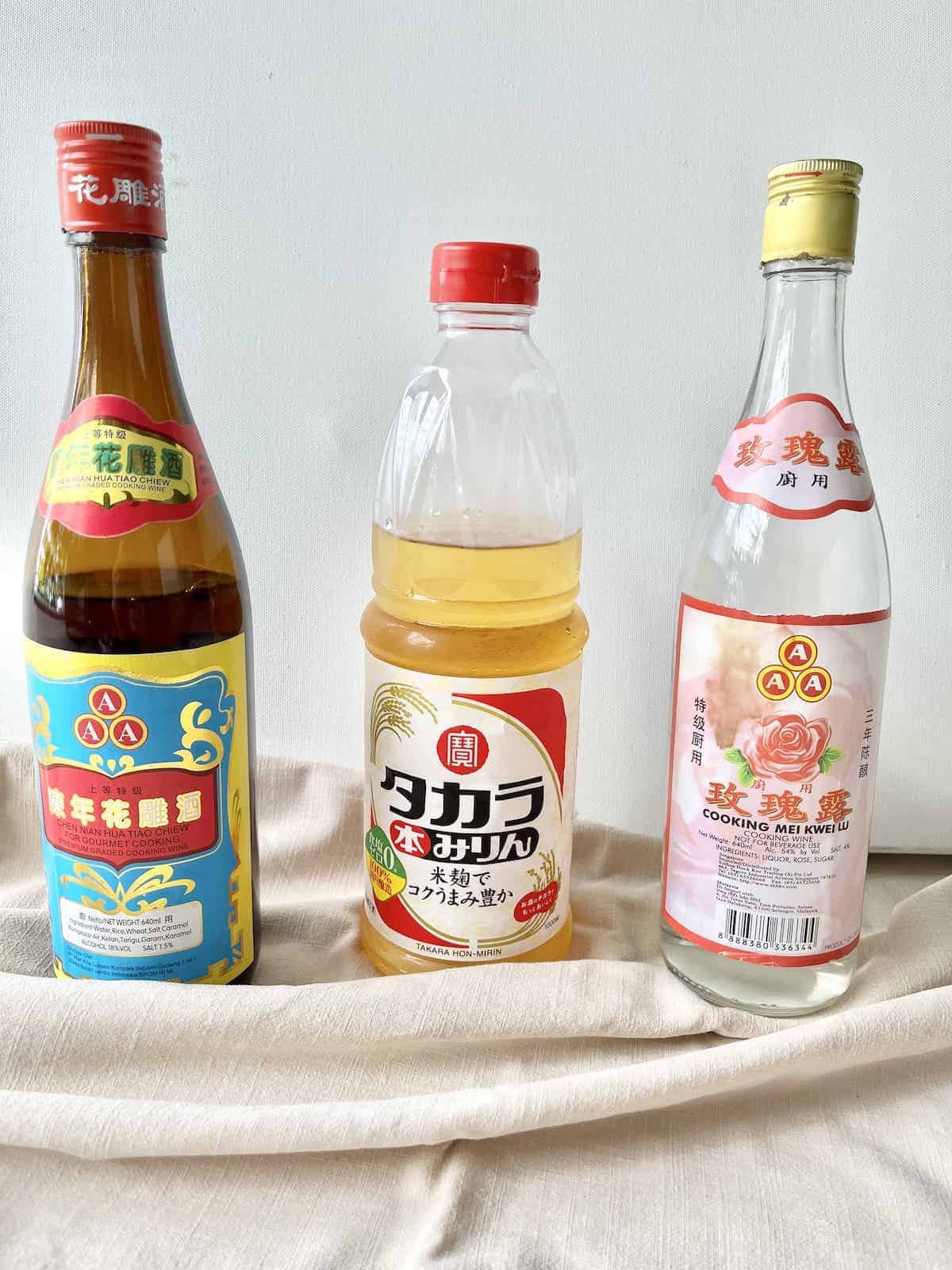 A bottle of Shaoxing (left), Mirin (middle), and Chinese rose wine (right.)