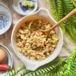 A spoon in a bowl of tuna fried rice.