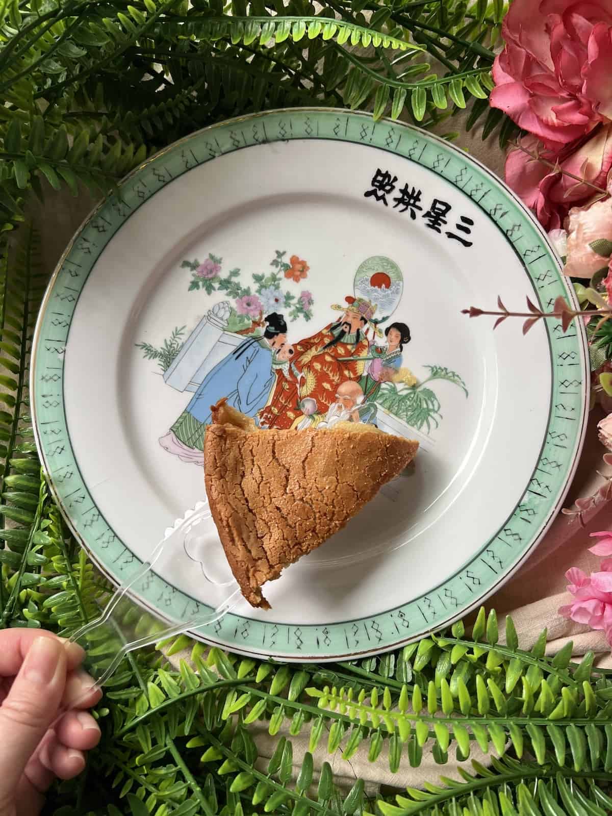 Slice of baked Nian Gao on a Chinese New Year plate.