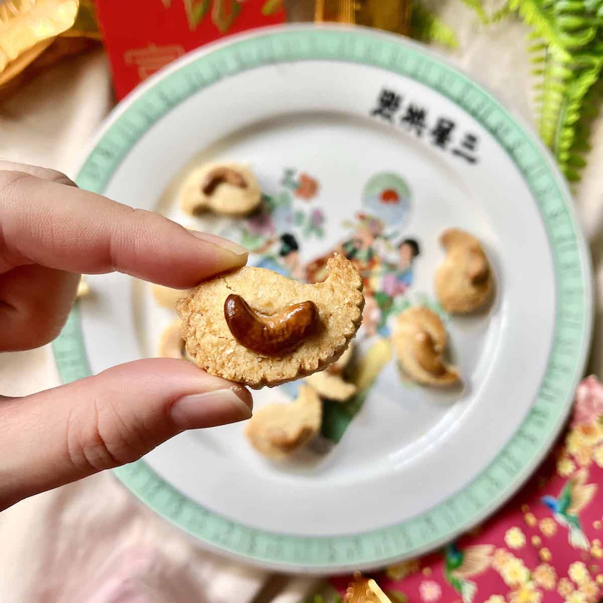 Close-up of a Chinese New Year cashew cookie with more in the background.