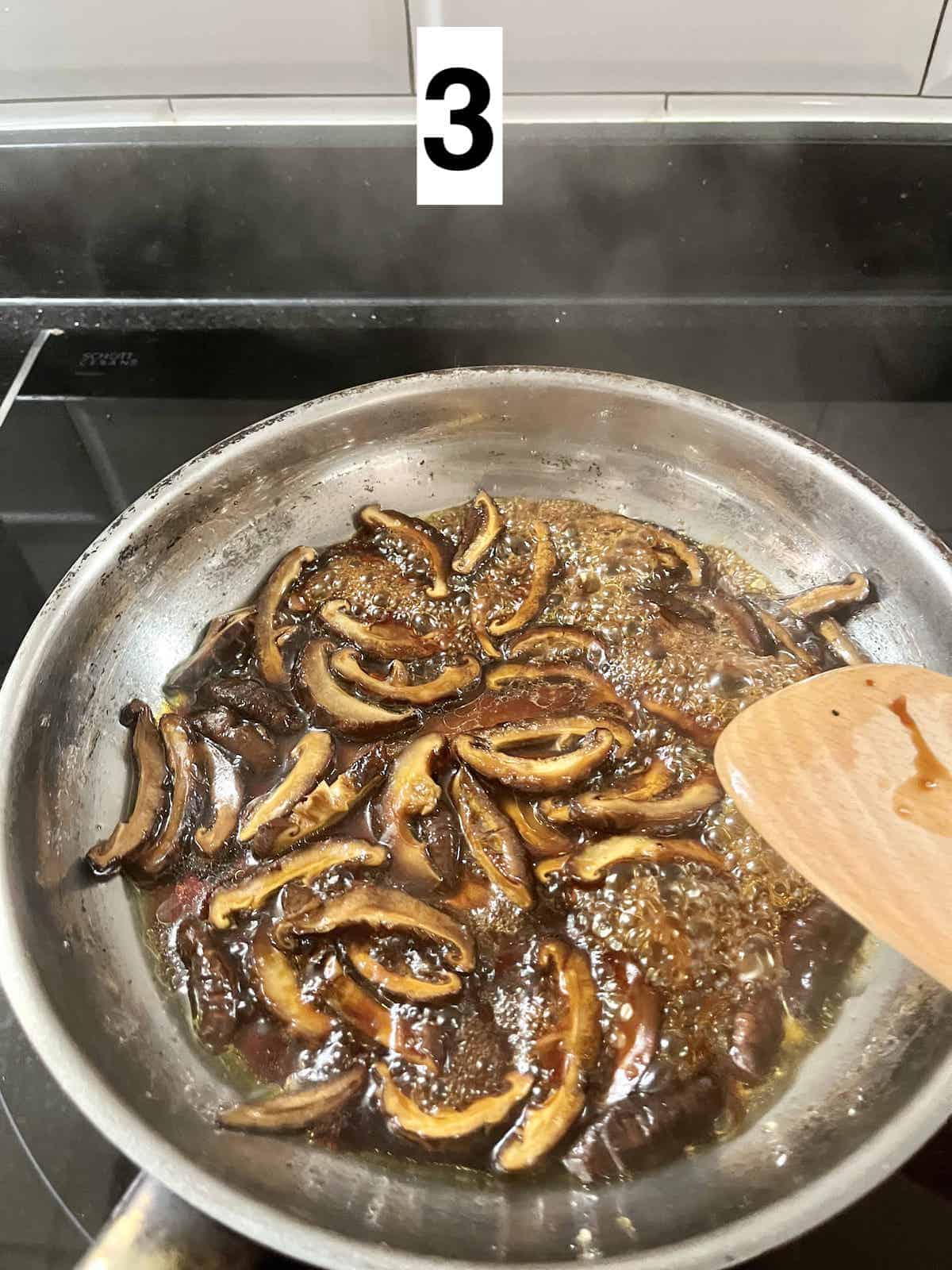 Stir frying mushrooms in teriyaki sauce.