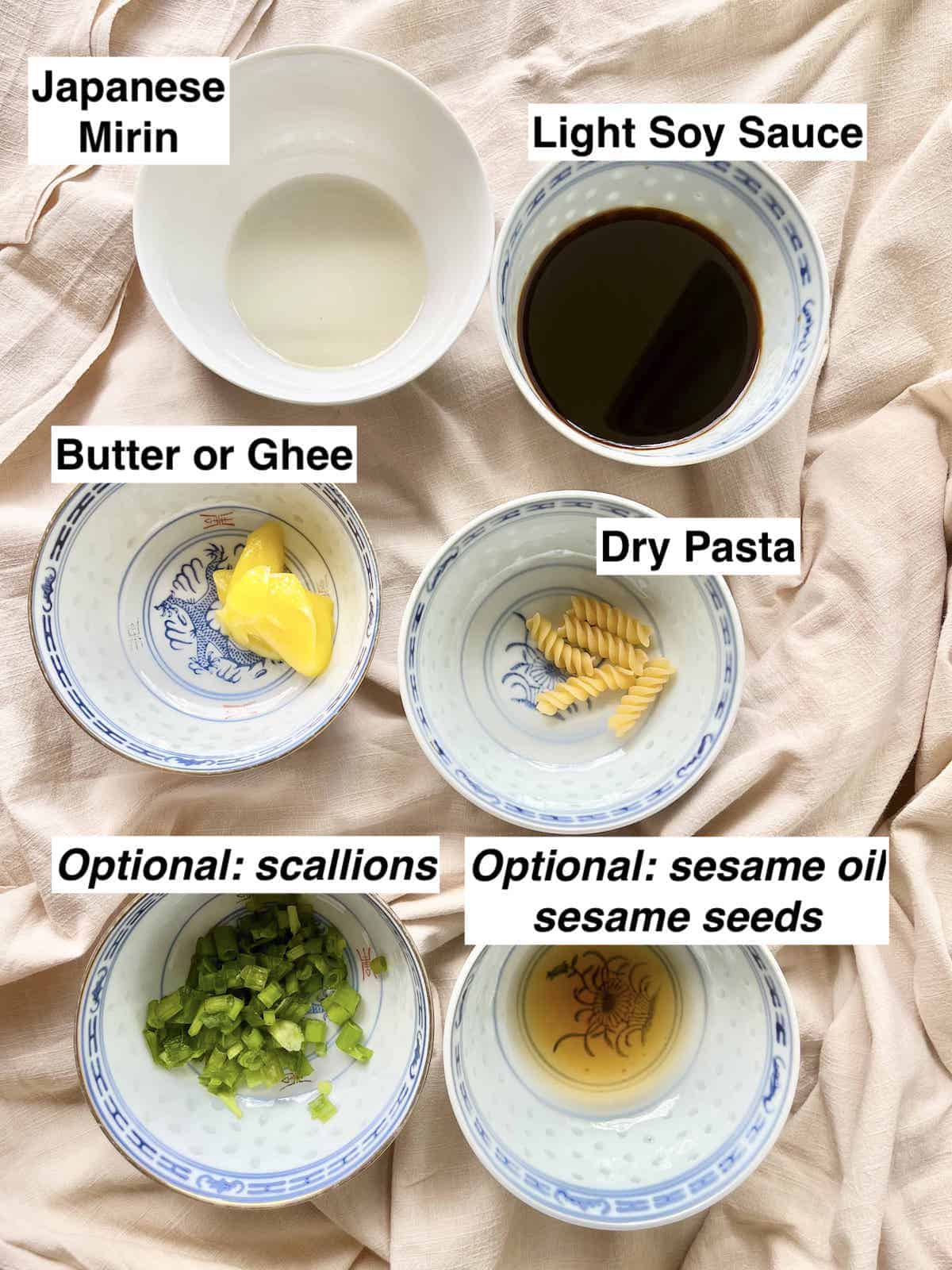 The ingredients for teriyaki pasta in bowls on a linen cloth.