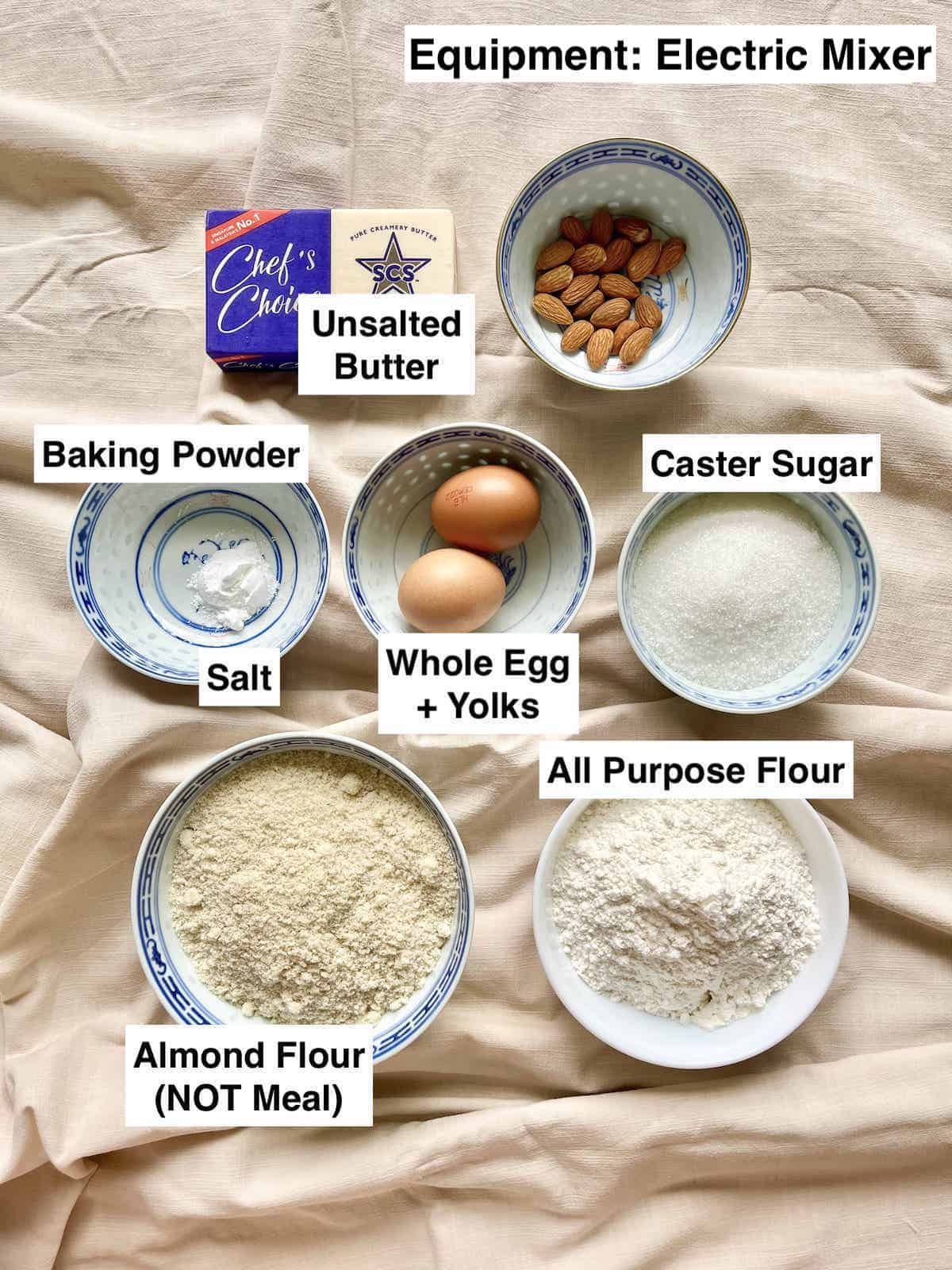 The ingredients for Chinese Butter Almond Cookies on a linen cloth.