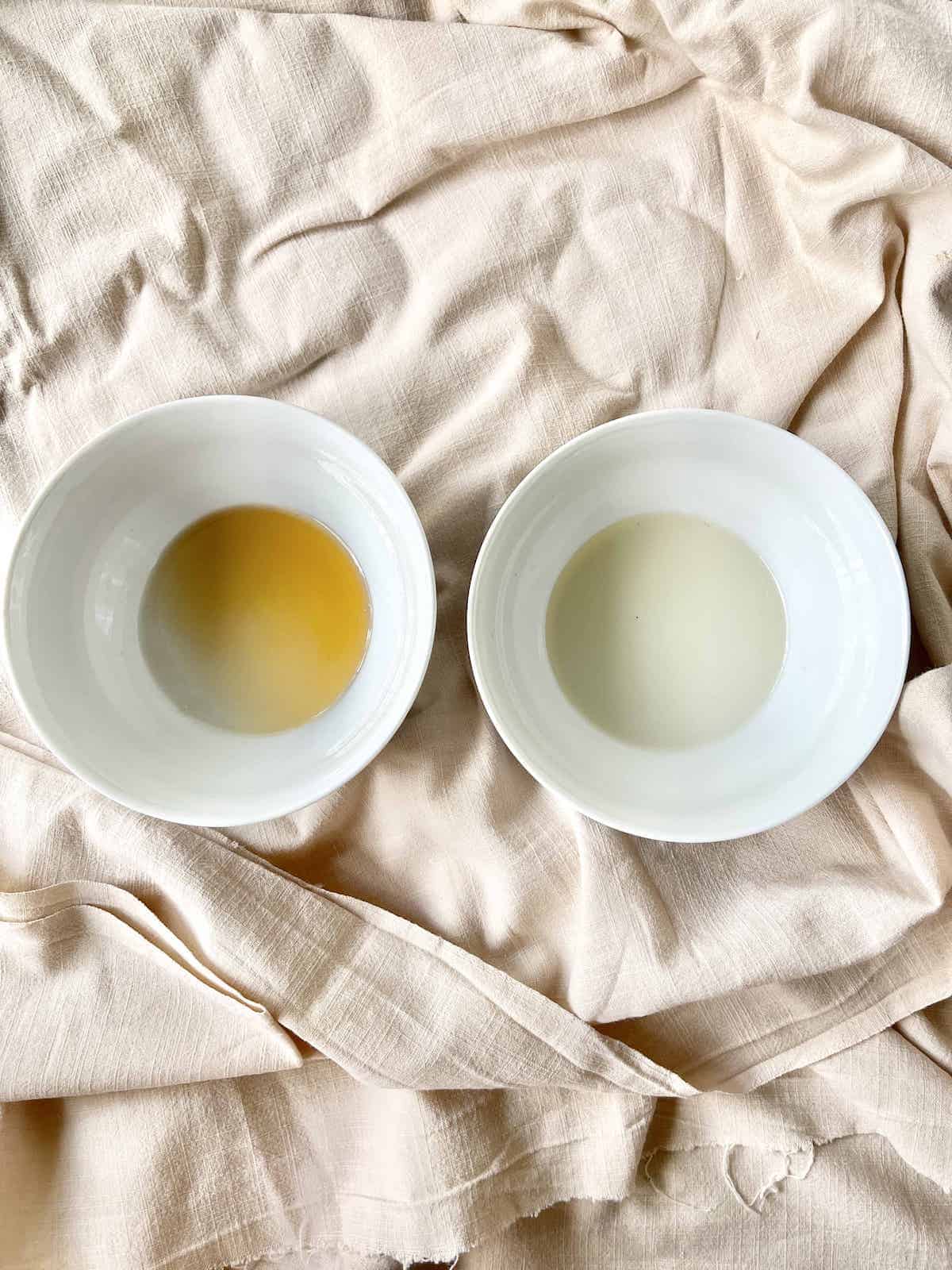 A bowl of Shaoxing wine next to a bowl of sake.