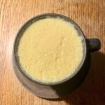 Overhead shot of a mug full of Golden Latte with Turmeric and Honey.