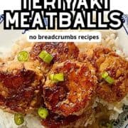 A pile of chicken teriyaki meatballs on a rice bowl.