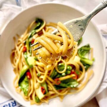 Close-up of a forkful of chow mein spaghetti noodles.
