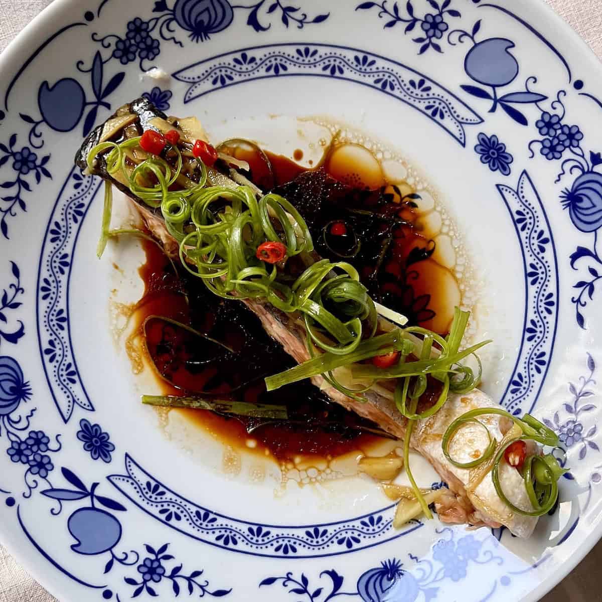 Chinese steamed salmon in a soy based sauce with spring onions.