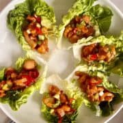 6 Korean Chicken lettuce wraps on a white plate.