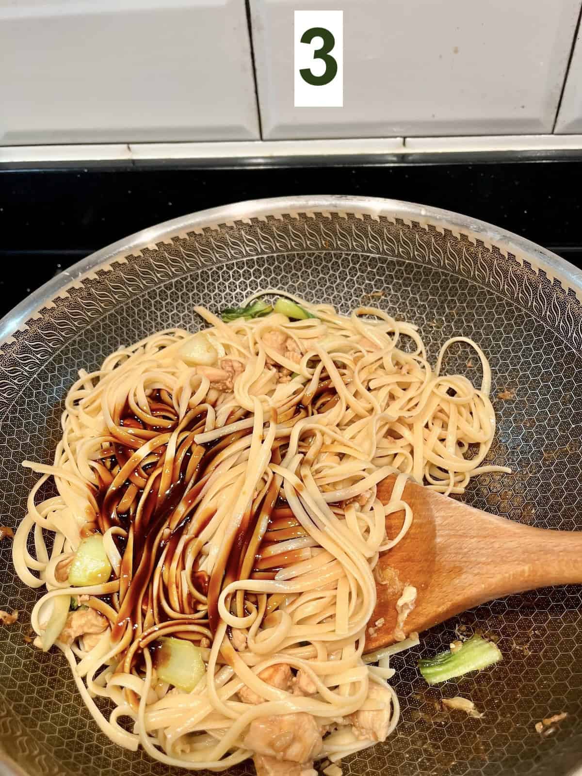 Adding lo mein sauce to spaghetti noodles.