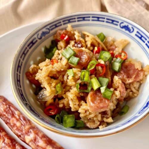 Chinese claypot rice with Chinese sausage and mushrooms in a bowl.