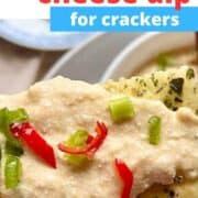 Philadelphia cream cheese dip spread on cracker close-up.