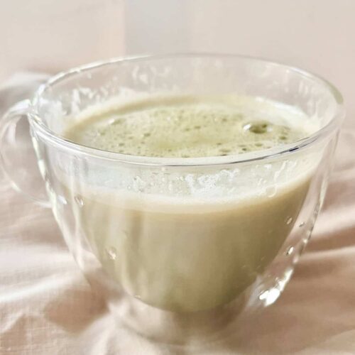 Matcha White Chocolate Drink in clear cup.