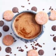 Overhead shot of mug of hot chocolate with chocolate around it.