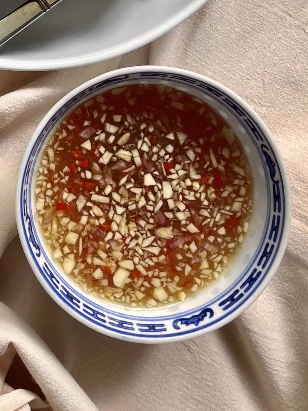 Vietnamese chili garlic sauce in a blue and white bowl.