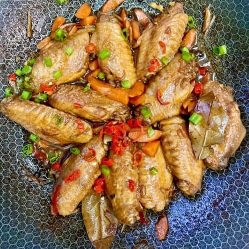 Filipino Chicken Wings in Adobo Sauce garnished with spring onions and chilies.
