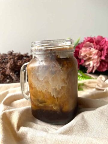 Iced caramel latte in a glass mug.