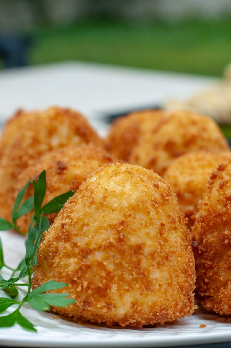 Close-up of fried Italian arancini balls.