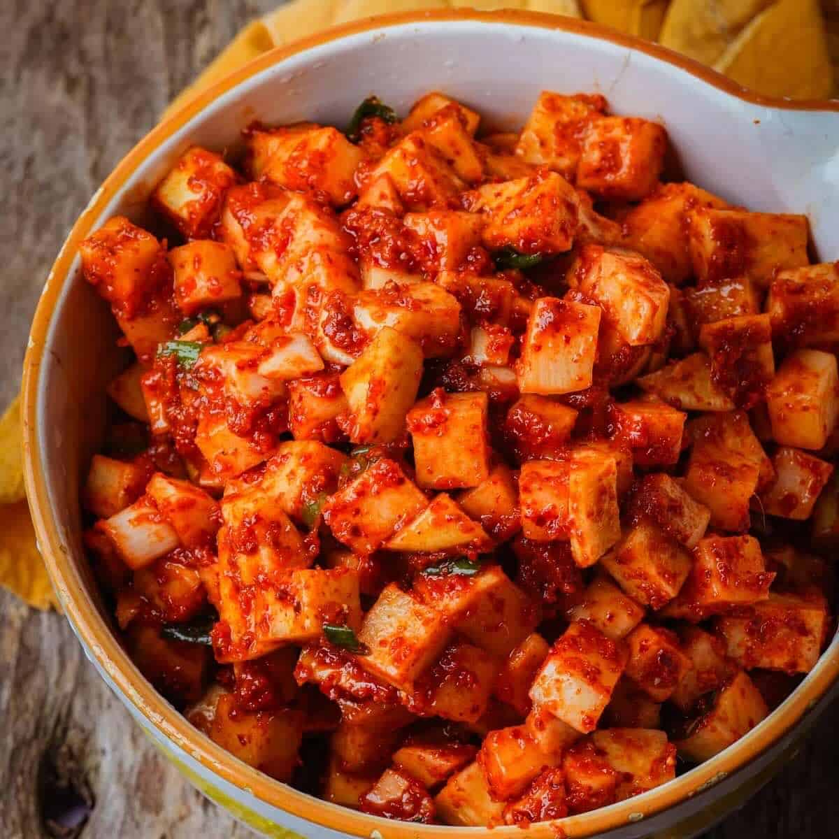 A bowl of spicy red vegan radish kimchi.