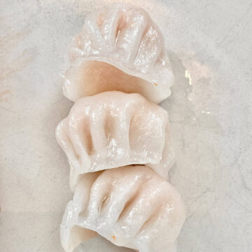 3 pieces of Chinese prawn dumplings (Har Gao) on a plate.