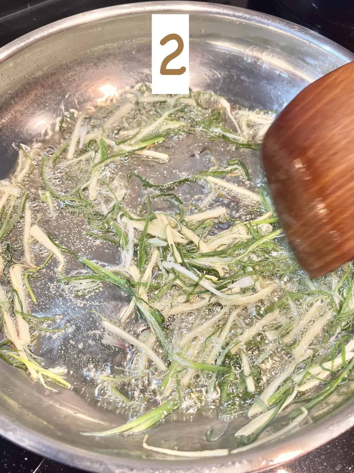 Stir frying scallions and ginger.